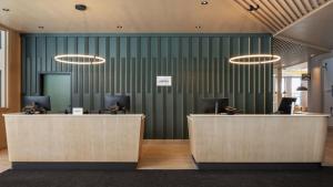 an office with two reception desks and a green wall at Residence Inn by Marriott Bromont in Bromont +27 photos