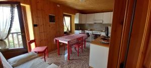 a kitchen with a table and chairs in a room at La gerbe d'or in Saint Nicolas