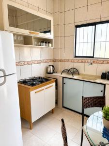 a kitchen with a sink and a stove top oven at Apartamento no Centro da Cidade Nova in Marabá