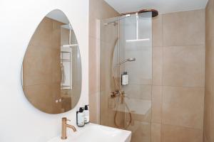 a bathroom with a shower and a sink with a mirror at Residence Paradis in Zandvoort +27 photos