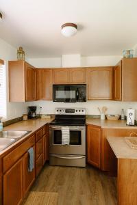a kitchen with wooden cabinets and a stove top oven at The Lighthouse in Moscow