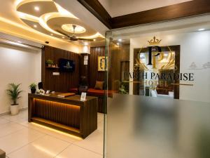 a lobby of a park paradise hotel with a reception desk at Parth Paradise Hotel in Indore