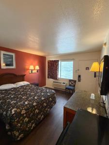 a hotel room with a bed and a desk at Travel Inn in Greensboro