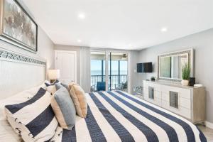 a bedroom with a large bed with a view of the ocean at Luxury Oceanfront Penthouse Condo in Clearwater Beach +39 photos