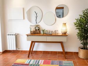 a dressing table with mirrors on the wall at Casa com Alma by LovelyStay in Fátima