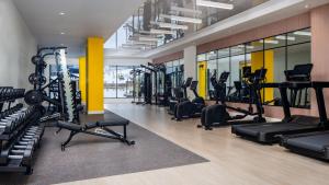 a gym with treadmills elliptical machines and treadleys at Residence Inn by Marriott Bromont in Bromont