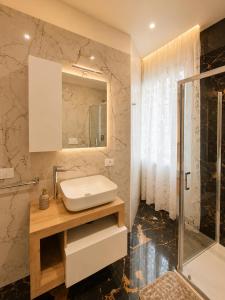 a bathroom with a sink and a shower at Villa Elysia Tropea in Tropea +45 photos