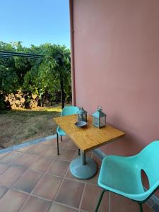 a wooden table and chairs on a patio at Almyra Seaside Apartments in Elia Laconias