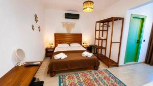 a bedroom with a bed with two towels on it at Mlinova Küçükköy in Ayvalık