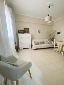 a living room with a chair and a dresser at Palaiopolis house in Kanoni