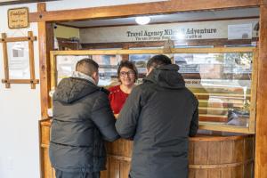 a group of three people looking at a woman at Nikos II Adventure in Puerto Natales +17 photos
