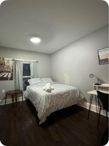 a bedroom with a bed with a teddy bear on it at Charming Cozy Getaway in Oneonta