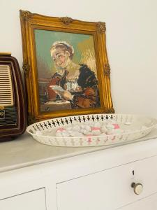 a painting of a woman in a picture on a shelf at Palaiopolis house in Kanoni
