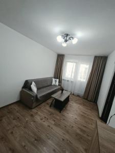 a living room with a couch and a coffee table at Codruta Home in Râmnicu Vâlcea