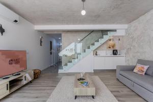 a living room with a couch and a staircase at GuestReady - Tranquil Oasis in Lagoa in Lagoa +57 photos