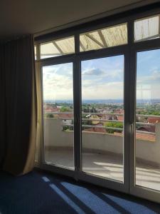a room with a large glass window with a view at The VIEW in Belgrade