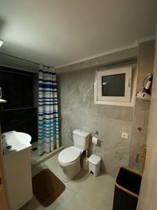 a bathroom with a toilet and a sink at Kurti Home in Agia Triada