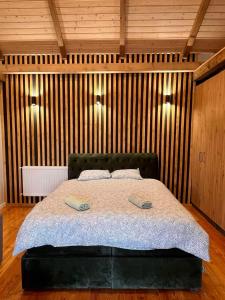 a bedroom with a bed with two pillows on it at Mount House Mavrovo in Mavrovo