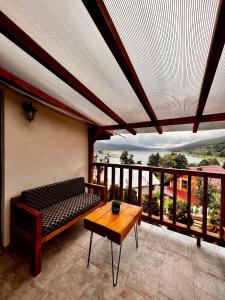 a room with a bench and a table on a balcony at Mount House Mavrovo in Mavrovo