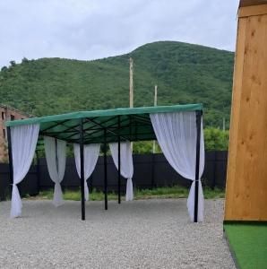 a ping pong table with white curtains on it at AnArt rezort in Vanadzor