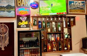 a bar with a bunch of bottles of alcohol at The Mountainstream Lodge in Lethem