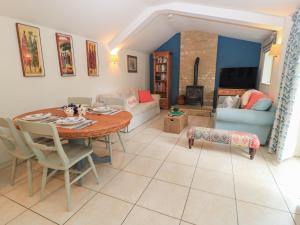 a living room with a table and a couch at Meadow Lodge in Cirencester