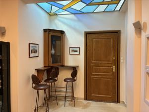 a room with a bar with stools and a skylight at Dream Home Thiva in Thiva