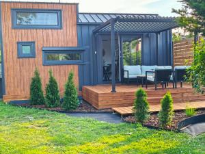 a house with a deck and a gazebo at Tiny Vinkel - Domki Tiny House Jastarnia in Jastarnia