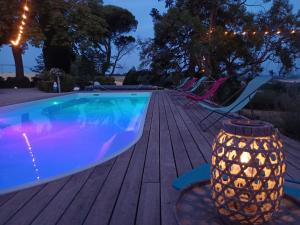 a swimming pool on a deck with a vase next to it at La chambre de Marin in Lombers +16 photos