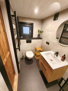 a bathroom with a sink and a toilet at Tiny Vinkel - Domki Tiny House Jastarnia in Jastarnia +27 photos