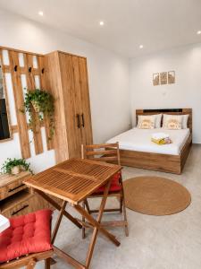 a bedroom with a bed and a table and a bed at Little Villa - walk to the beach in Thessaloniki
