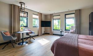 a bedroom with a bed and a table and chairs at Bij Corine, bed en zorg in Altforst