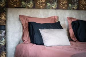 a bed with two black pillows and a white pillow at Bij Corine, bed en zorg in Altforst