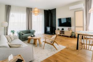 a living room with a couch and a tv at Oakville House - Kosmaj - Avala in Mala Ivanča