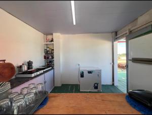 a kitchen with a stove and a refrigerator at Casa sol in Bragança