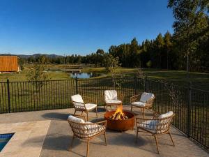 a group of chairs around a fire pit on a patio at Shiraz Vineyard Estate in Pokolbin