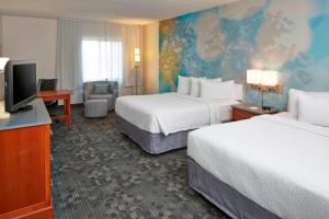 a hotel room with two beds and a flat screen tv at Courtyard by Marriott Bloomington Mall of America in Bloomington +37 photos