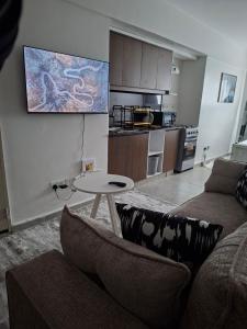 a living room with a couch and a table at Luna Homes at Tsavo Sunset, Kiambu Road in Kiambu