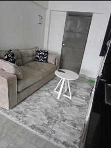 a living room with a couch and a table at Luna Homes at Tsavo Sunset, Kiambu Road in Kiambu