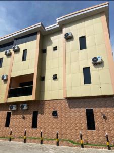 a large building with windows on the side of it at Goldstep Hotel Asaba in Asaba