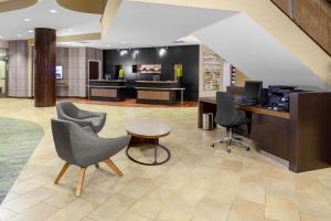 an office with two chairs and a desk and a table at Courtyard Memphis Downtown in Memphis