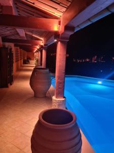 a patio with two large pots under a pergola at L'Hacienda in Mialet +41 photos