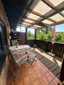 a patio with a table and chairs on a deck at Oase für Reisende & Geschäftsleute in Meerbusch