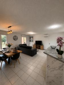 a living room with a couch and a table at Maison Mirepoix 100m2 in Mirepoix