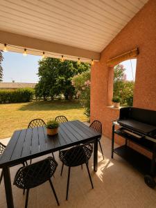 a table and chairs on a patio with a piano at Maison Mirepoix 100m2 in Mirepoix