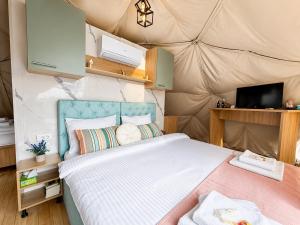 a bedroom with a bed in a tent at Sutjeska Glamping Domes in Tjentište