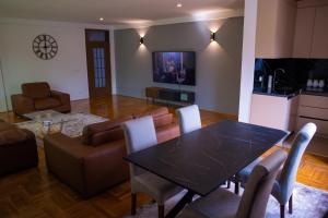 a living room with a table and a couch at Hotel Impex in Peje