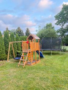 a playground with a slide and a swing at Chata na Karpackiej in Kostrzyca