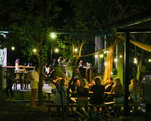 a group of people sitting at tables at night at Hotel Café Con Leche in Playa Santana +51 photos