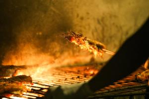 a piece of food is cooking on a grill at Hotel Café Con Leche in Playa Santana